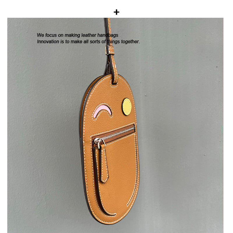 头层牛皮笑脸手机包真皮卡通图案挂脖小包包女2025新款单肩斜挎包