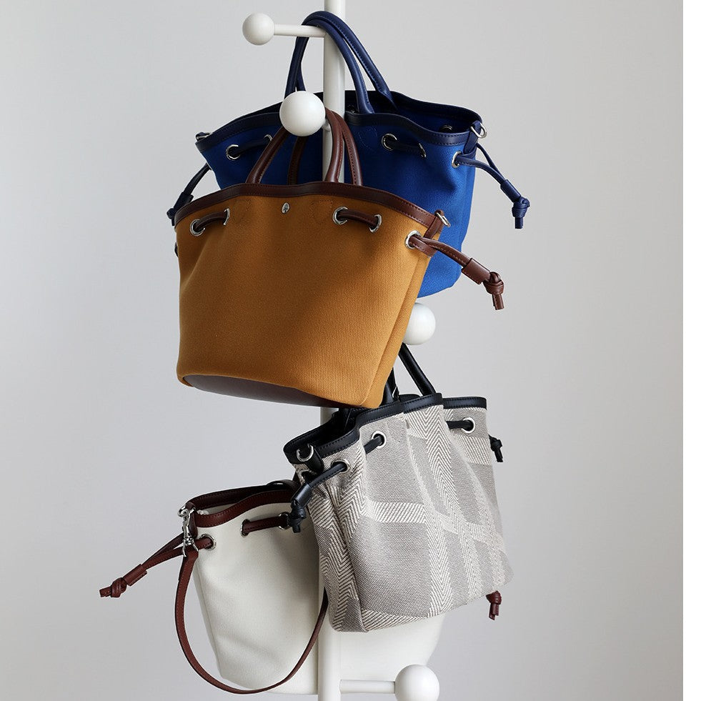 韩版休闲百搭ins通勤帆布包包女2025夏季手提斜跨包真皮托特包潮